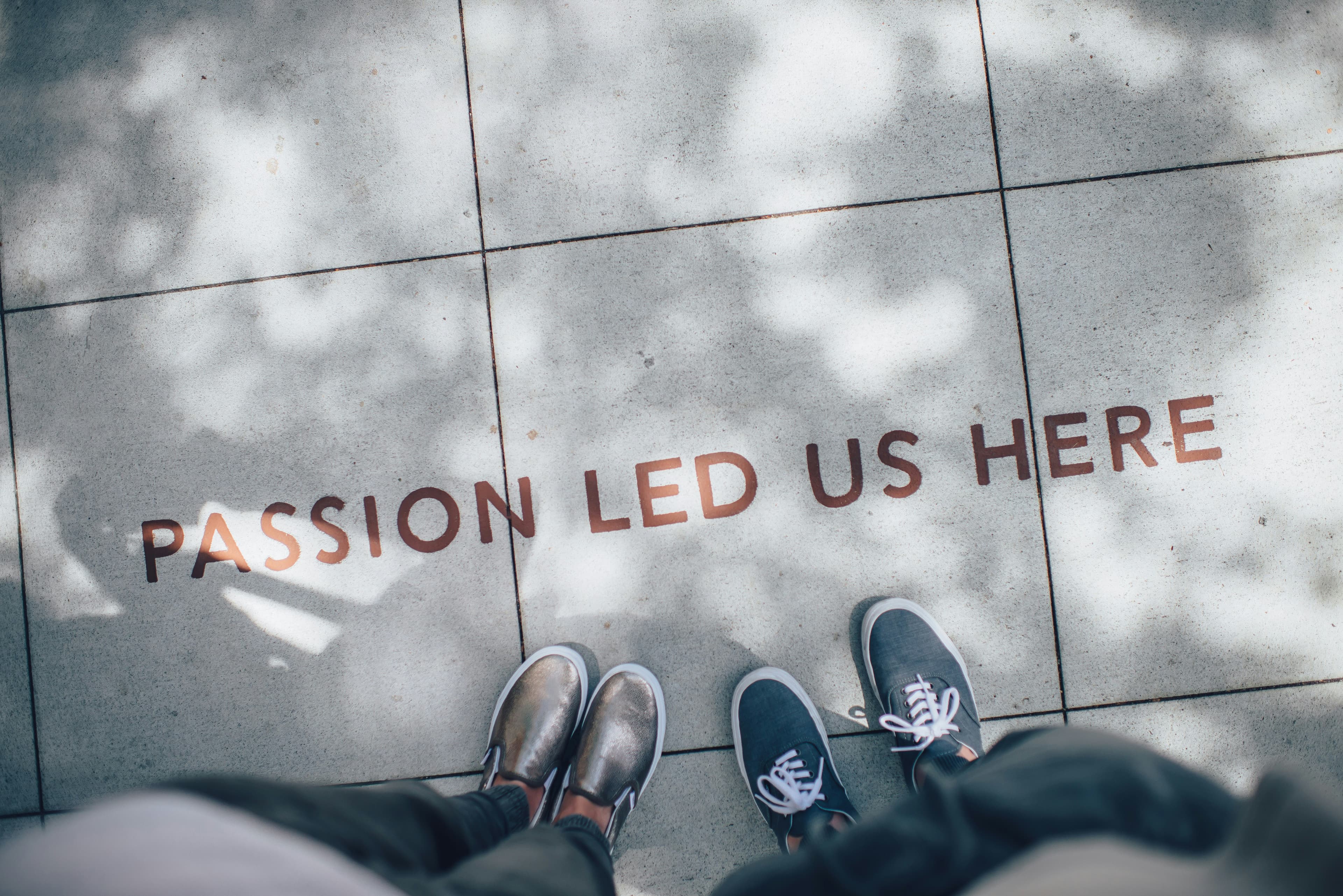 Passion led us here - feet standing on sidewalk